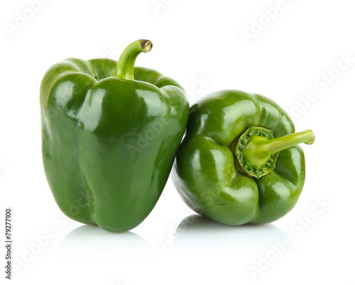 Close-up shot of two green bell peppers isolated on white