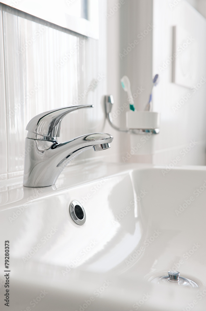 White sink with Steel faucet in a bathroom White sink with Steel faucet in a bathroom