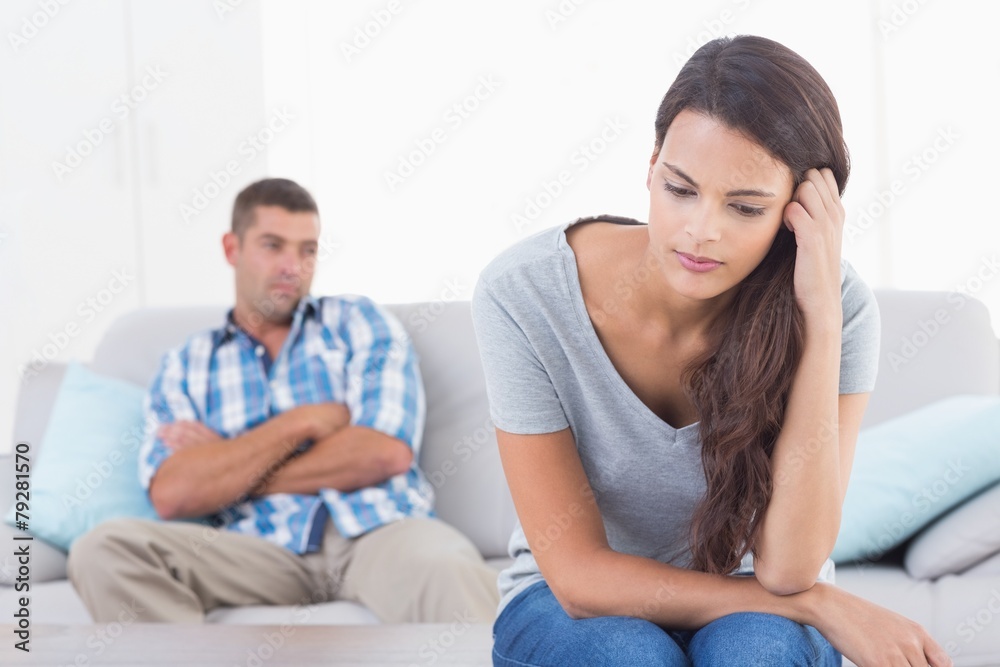 Angry woman sitting in front of man Angry woman sitting in front of man