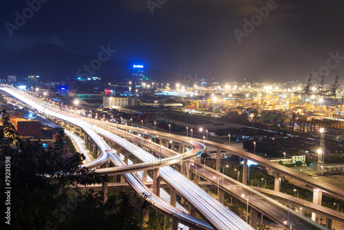 Illuminated and elevated expressway and cityscape at night