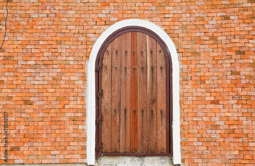 Wooden door on a brick wall.
