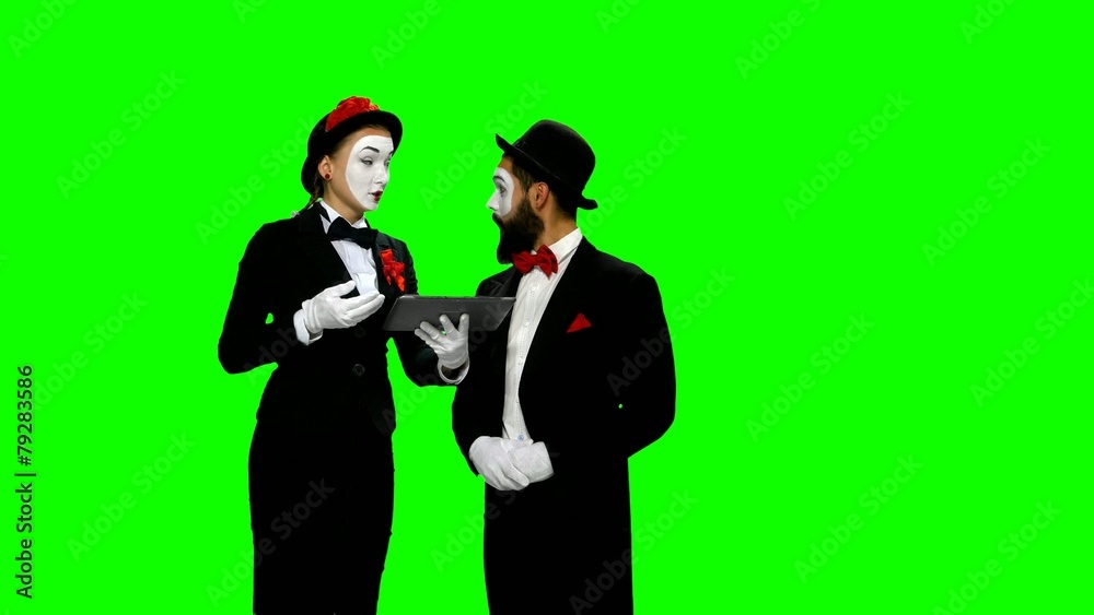 Two memes dicusses something using tablet computer on green Two memes dicusses something using tablet computer on green