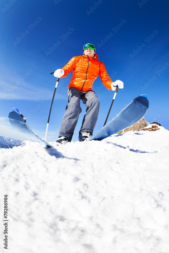Active young man ready to skiing view from below