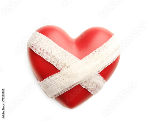 Tied heart with bandage isolated on white