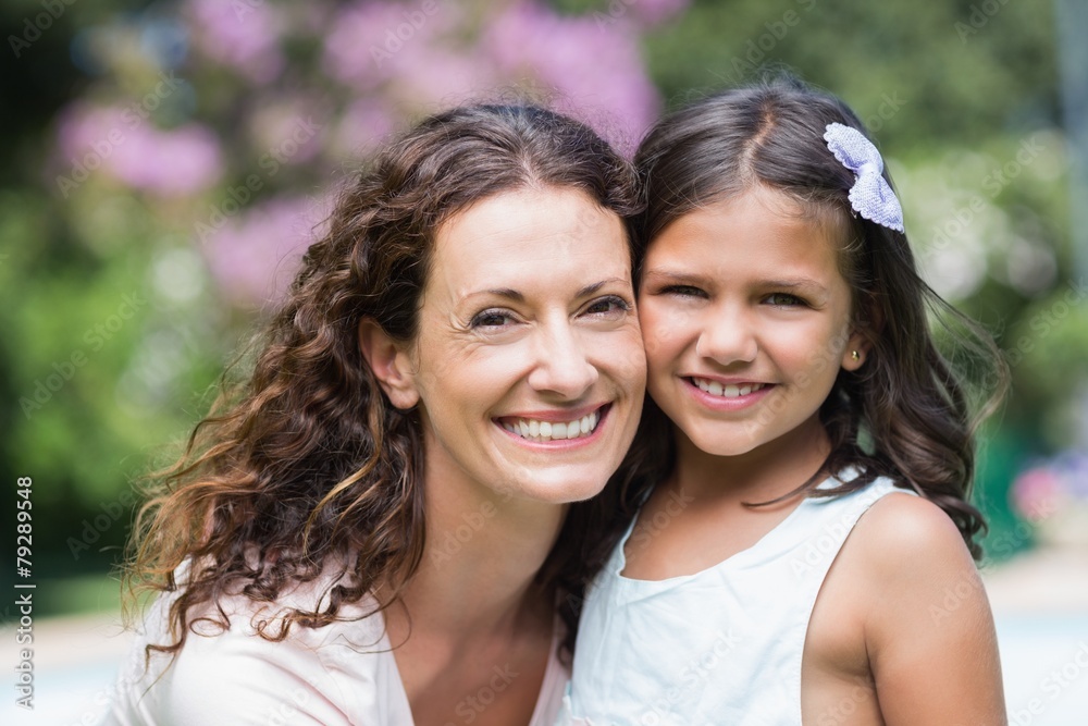 Happy mother and daughter smiling at camera Happy mother and daughter smiling at camera
