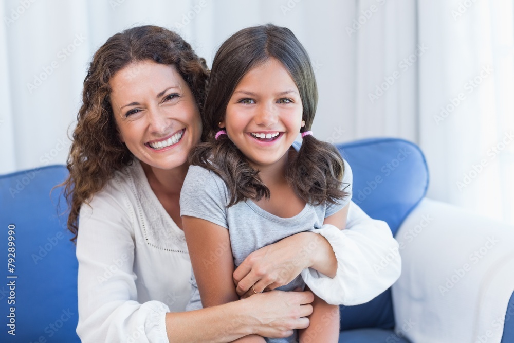 Happy mother and daughter smiling at camera