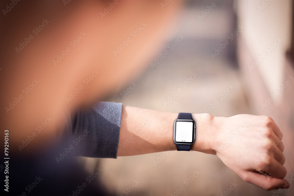 Hand wearing elegant smartwatch with blank screen.