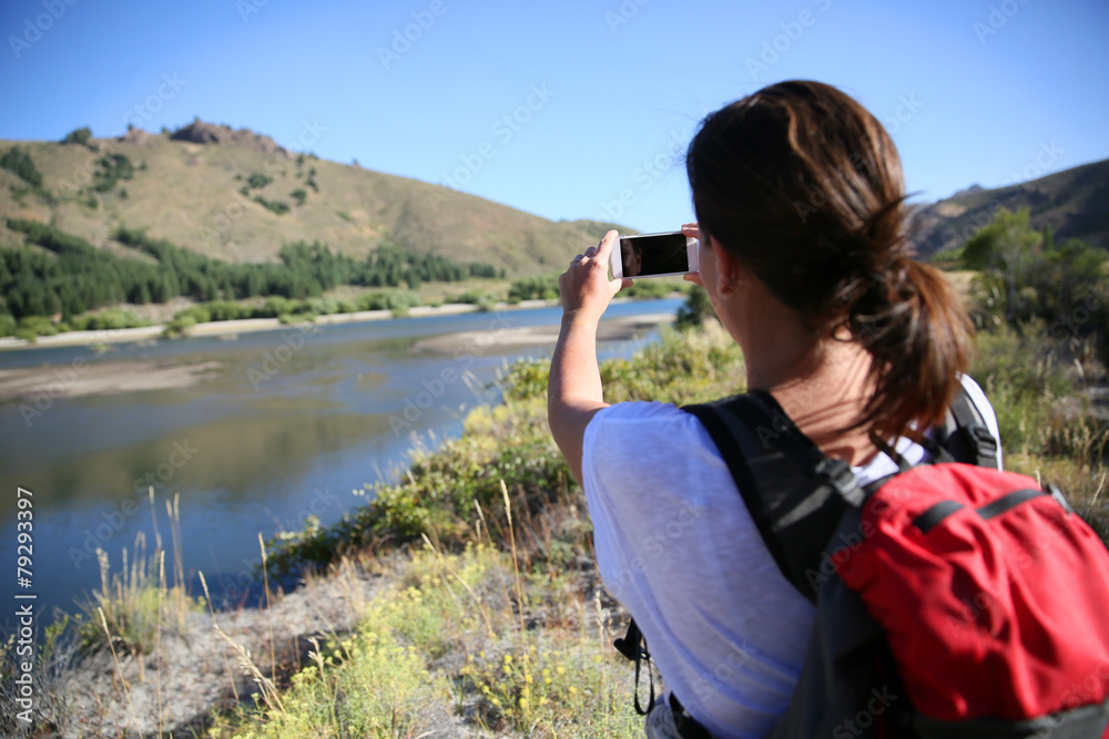 Backpacker taking picture of Limay river, Patagonia