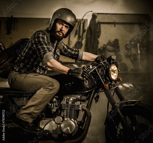 Rider and his vintage style cafe-racer motorcycle 