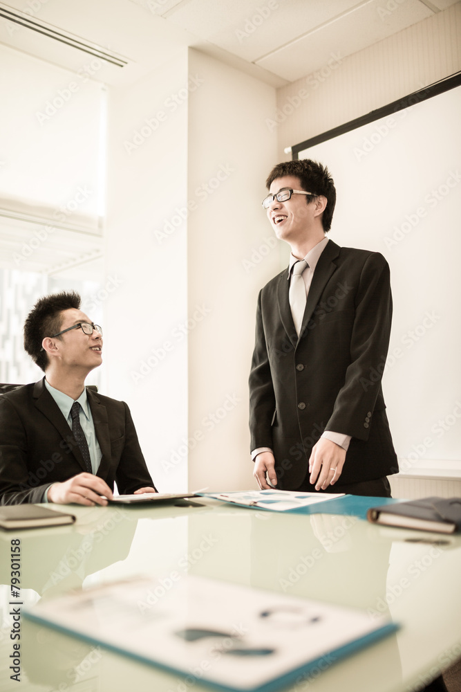 Businessman standing in front of colleagues during a meeting Businessman standing in front of colleagues during a meeting