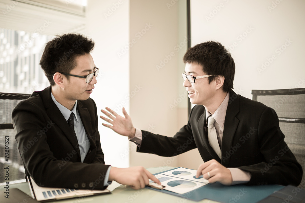 Two Businessmen Having Informal Meeting In Modern Office Two Businessmen Having Informal Meeting In Modern Office