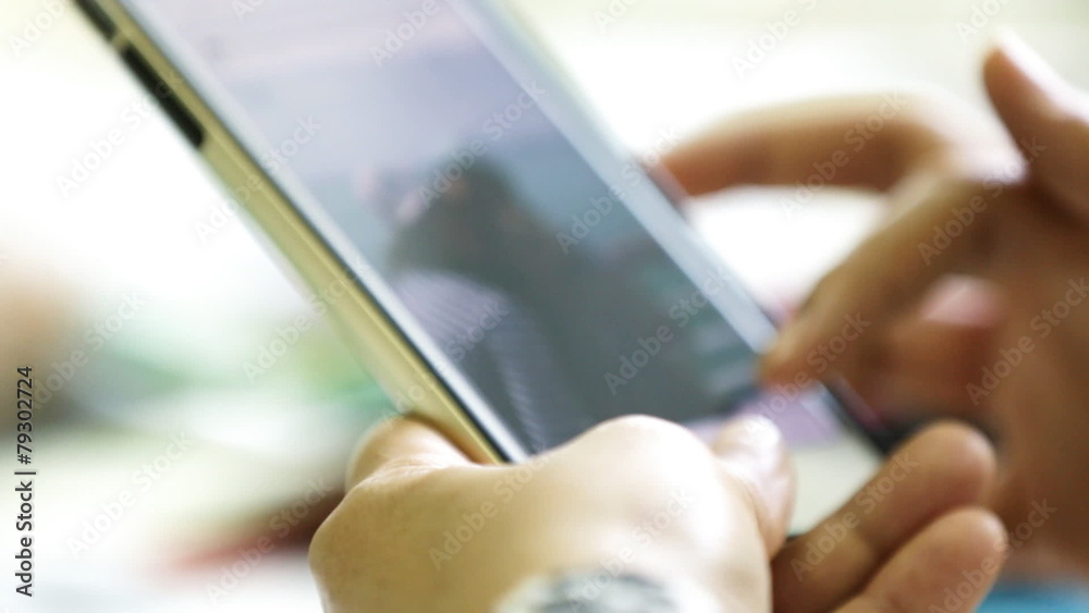 Woman's hands texting on smartphone at home . Woman's hands texting on smartphone at home .