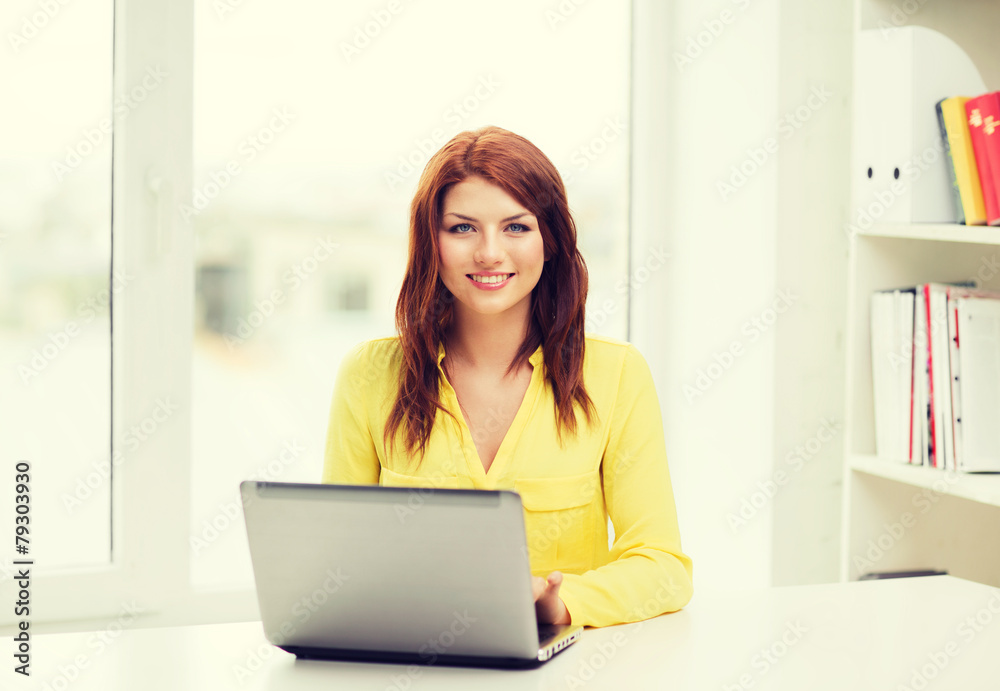smiling student with laptop computer at school