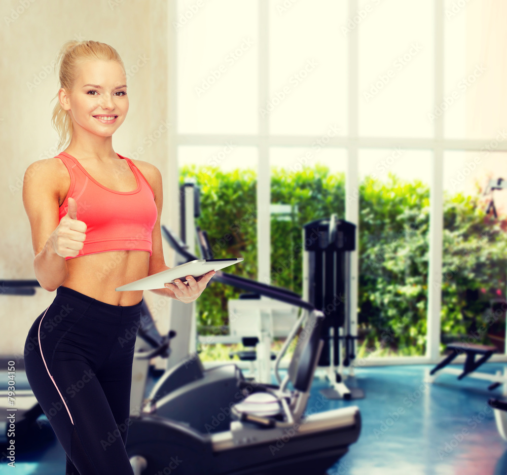 Fototapeta premium smiling sporty woman with tablet pc computer