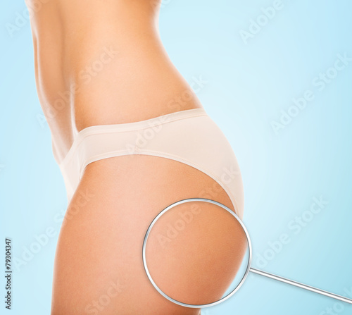 close up of woman buttocks and magnifier