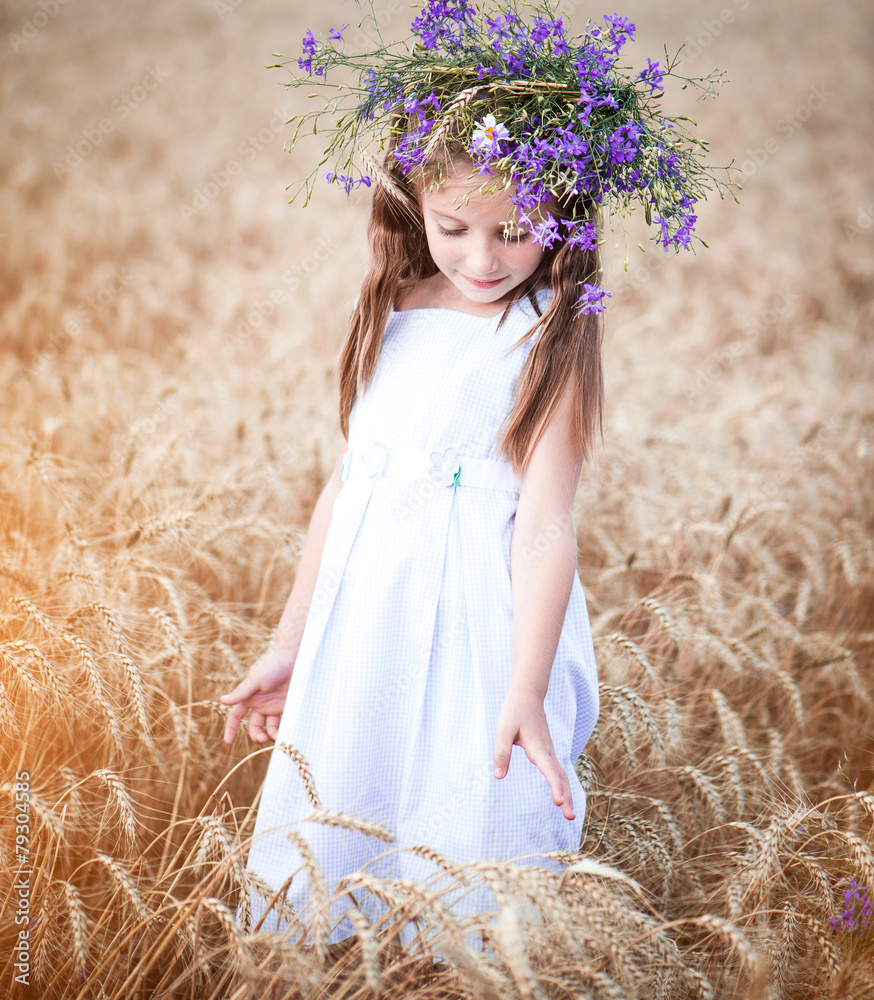 beautiful little girl in a field of wheat Stock Photo | Adobe Stock