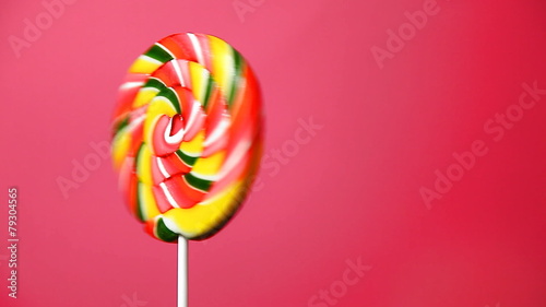 lollipop in the form of an round on a pink background