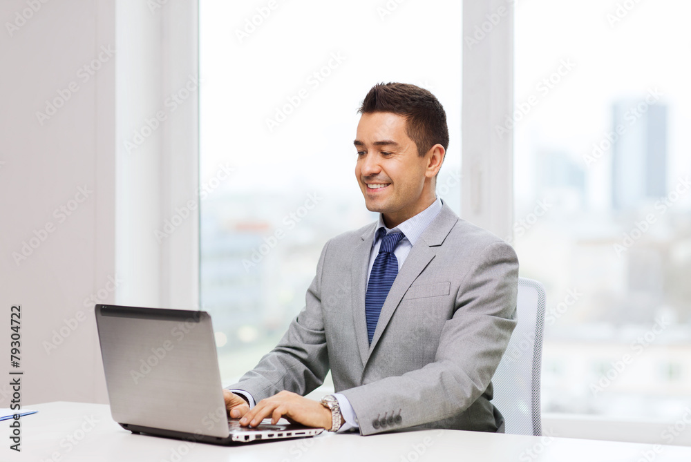 happy businessman working with laptop in office happy businessman working with laptop in office