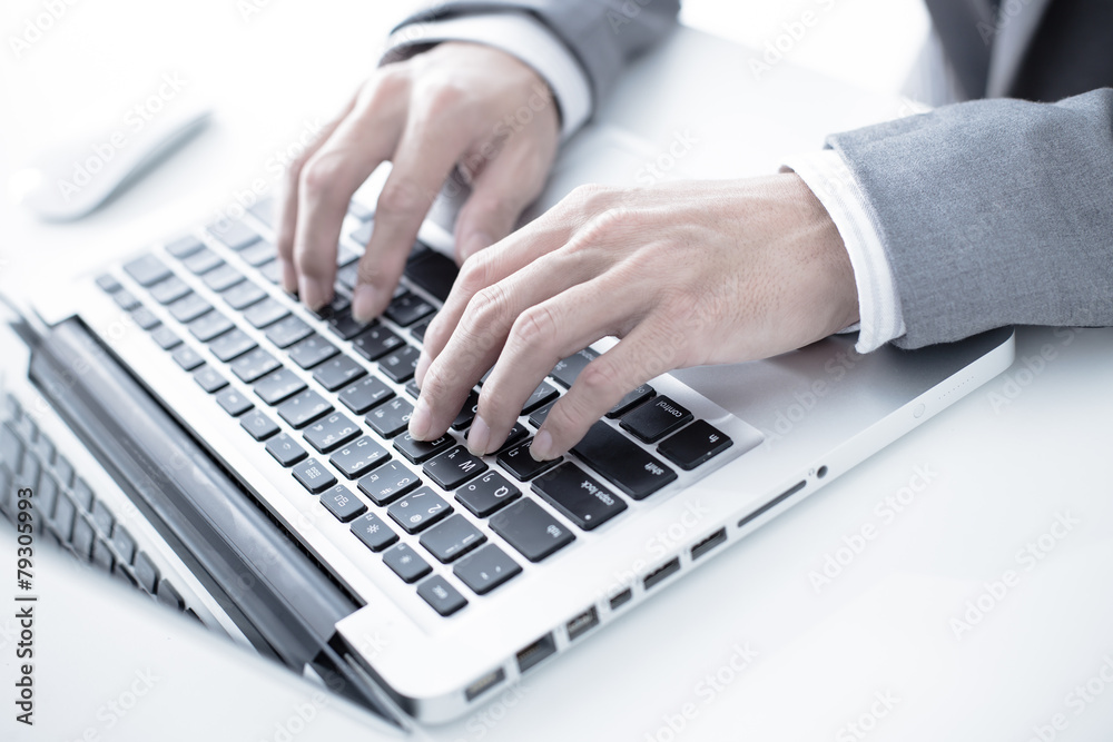 Closeup of businessman hands typing on laptop computer Closeup of businessman hands typing on laptop computer