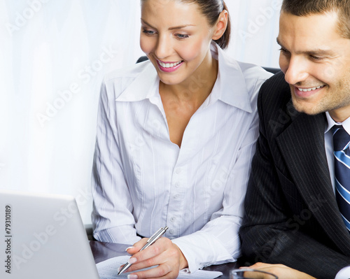 Portrait of happy young businesspeople working photo