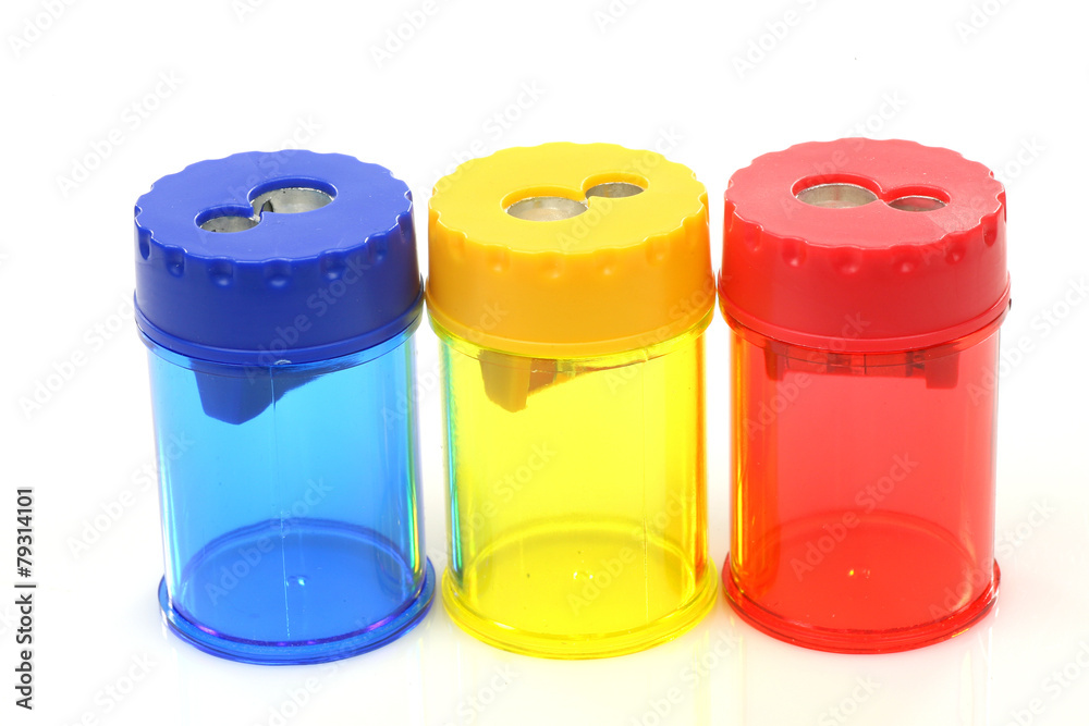 three colorful plastic pencil sharpeners on a white background three colorful plastic pencil sharpeners on a white background
