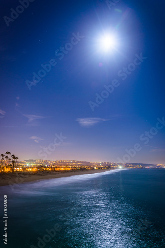 A full moon over the Pacific Ocean at night, seen from Balboa Pi