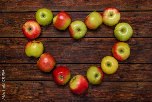 heart from fresh apples on wooden table