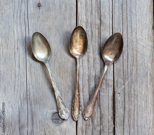 Vintage spoons with patina on wood