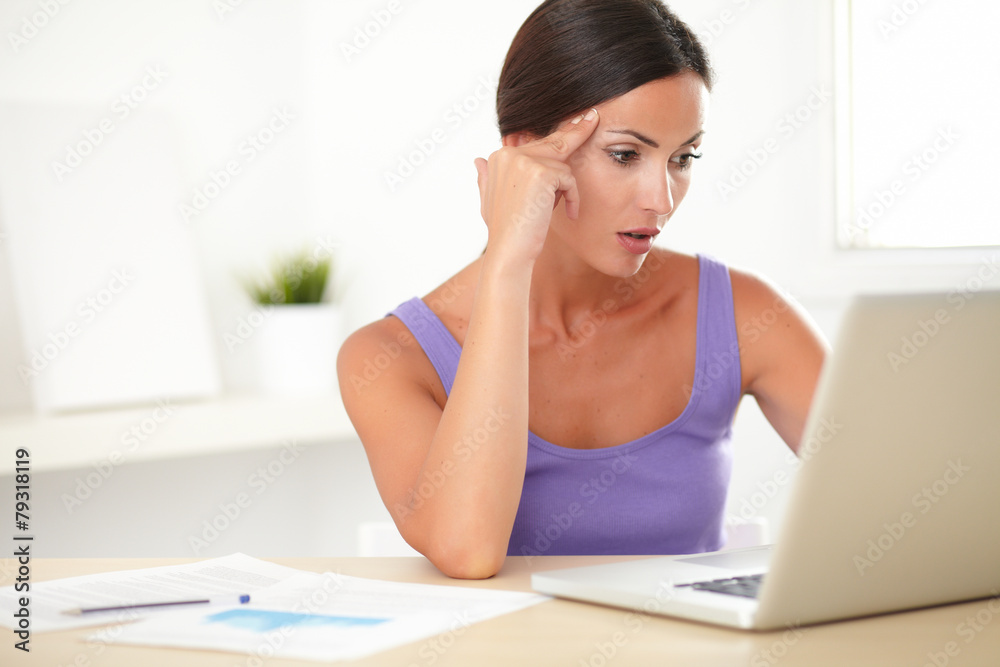 Elegant young woman sitting and surfing the web Elegant young woman sitting and surfing the web