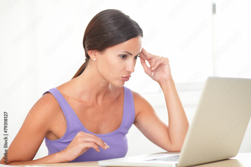 Obraz premium Fatigued lady surfing the web on computer