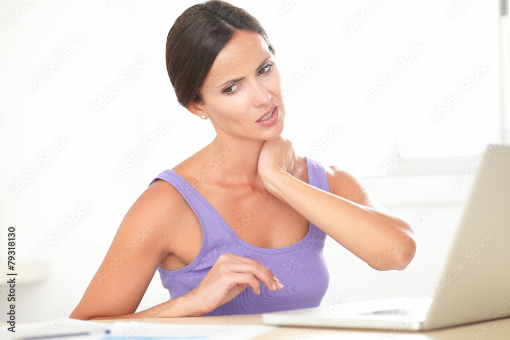Pretty woman with neck pain working at home Pretty woman with neck pain working at home