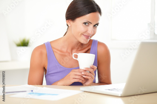 Adult woman sitting and surfing the web