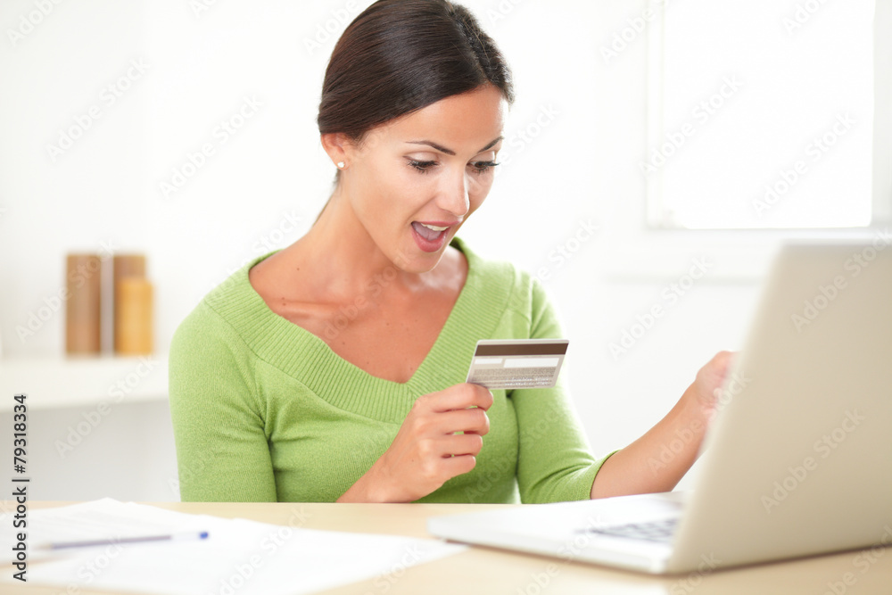 Shocked woman shopping with her credit card