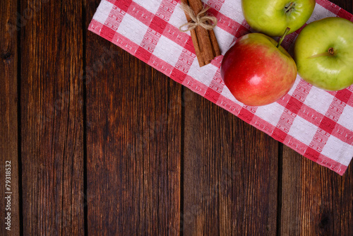 fresh apples with cinnamon on wooden table copy space