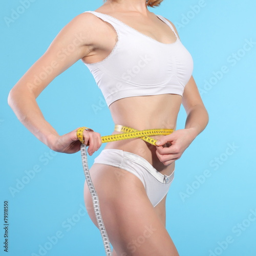 woman with measure tape over white