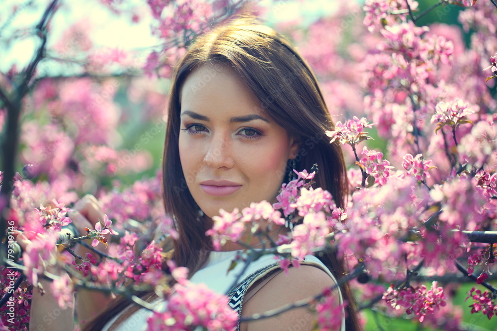 girl in flowers of apple tree