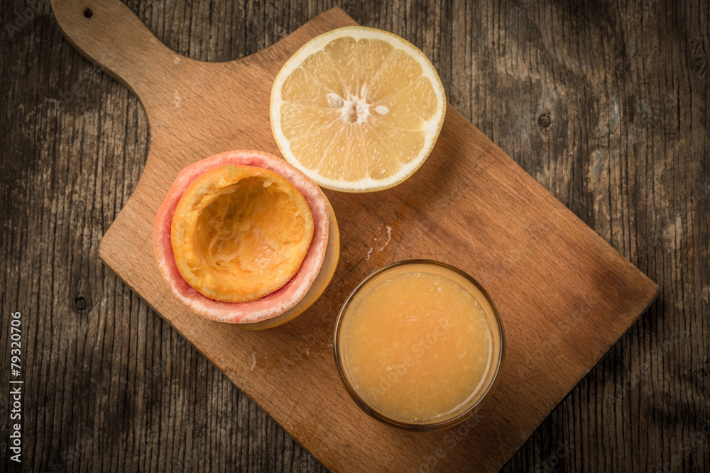 Juice glass and fresh citrus fruit on rustic wood.Fresh healthy Juice glass and fresh citrus fruit on rustic wood.Fresh healthy