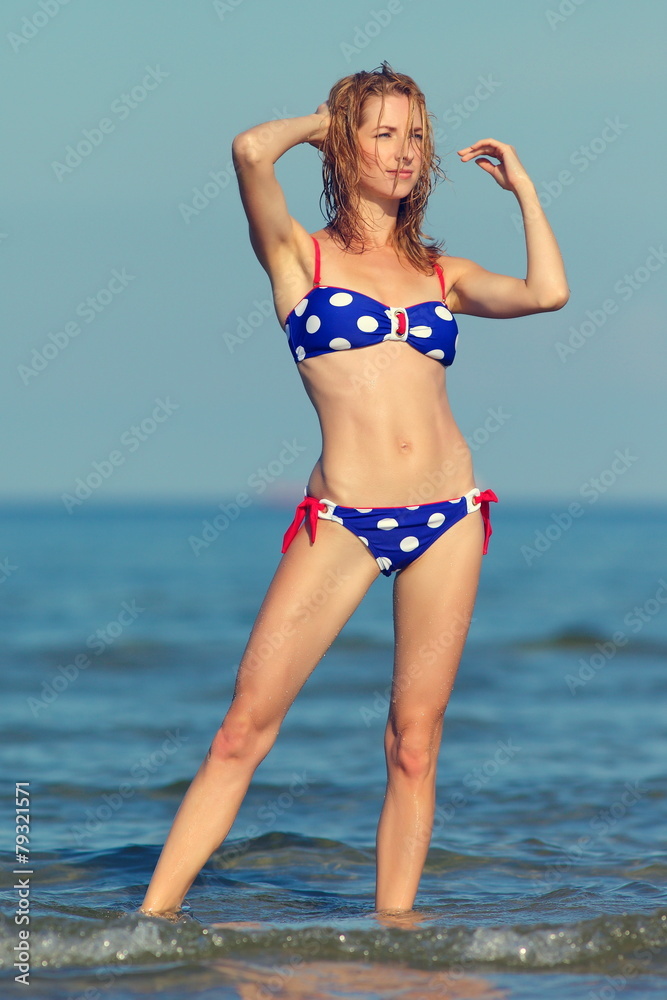 young sexy girl in a swimsuit at the sea