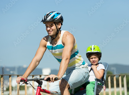 Father with child on bicycle