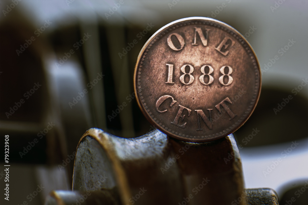 Old one cent coin on a violin scroll Old one cent coin on a violin scroll