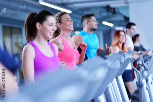 Group of people running on treadmills