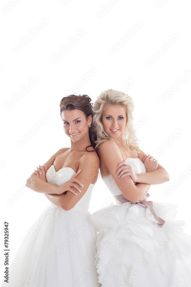 Nice girlfriends posing in elegant wedding dresses