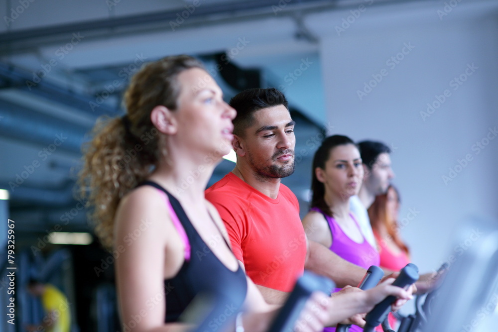 Group of people running on treadmills