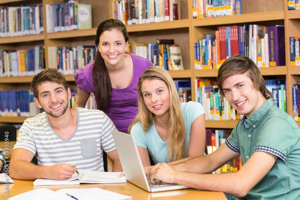 College students doing homework in library College students doing homework in library