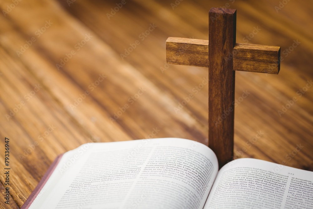 Fototapeta premium Open bible with crucifix icon behind