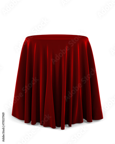 Round pedestal with red cloth over white background