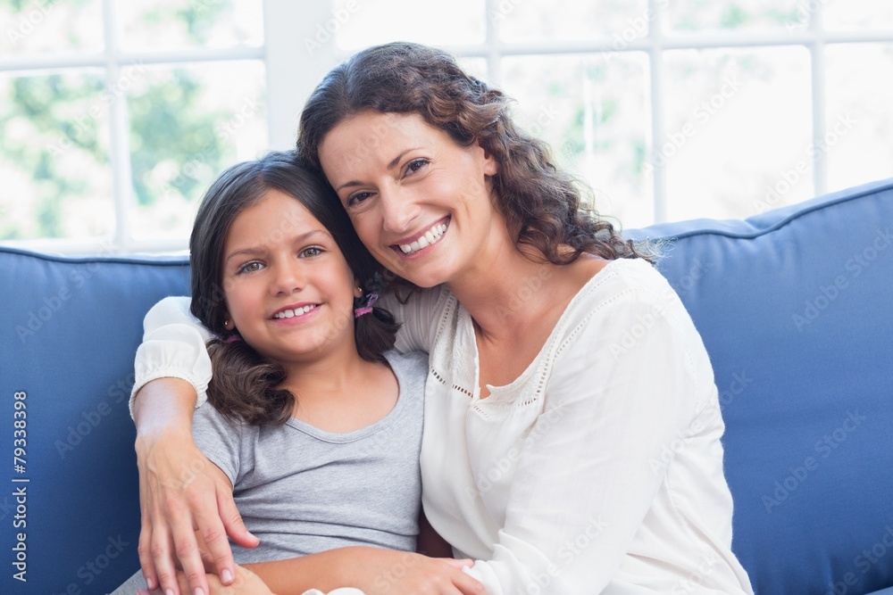 Happy mother and daughter smiling at camera Happy mother and daughter smiling at camera