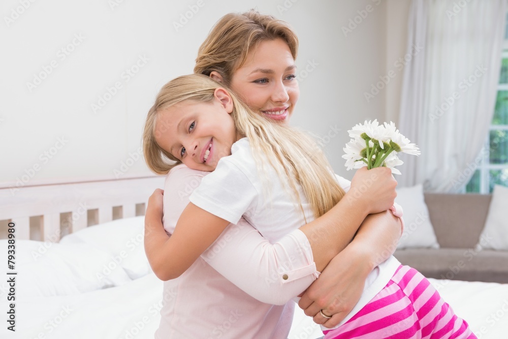 Mother and daughter hugging with flowers Mother and daughter hugging with flowers