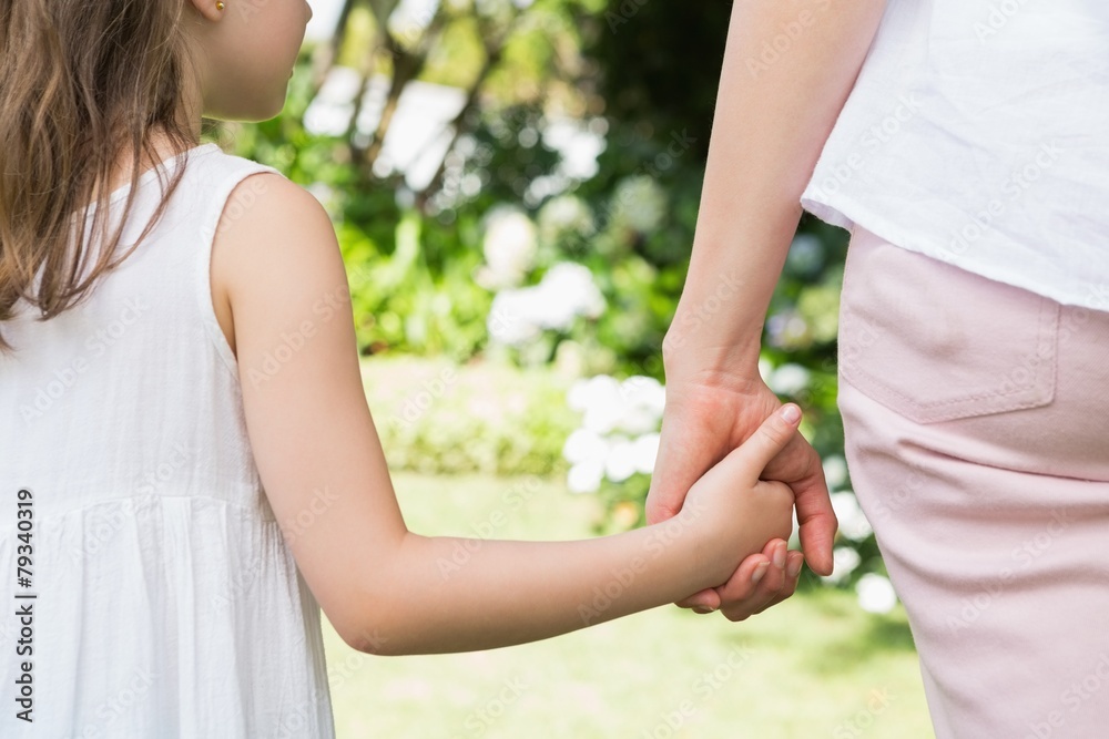 Mother and daughter holding hands