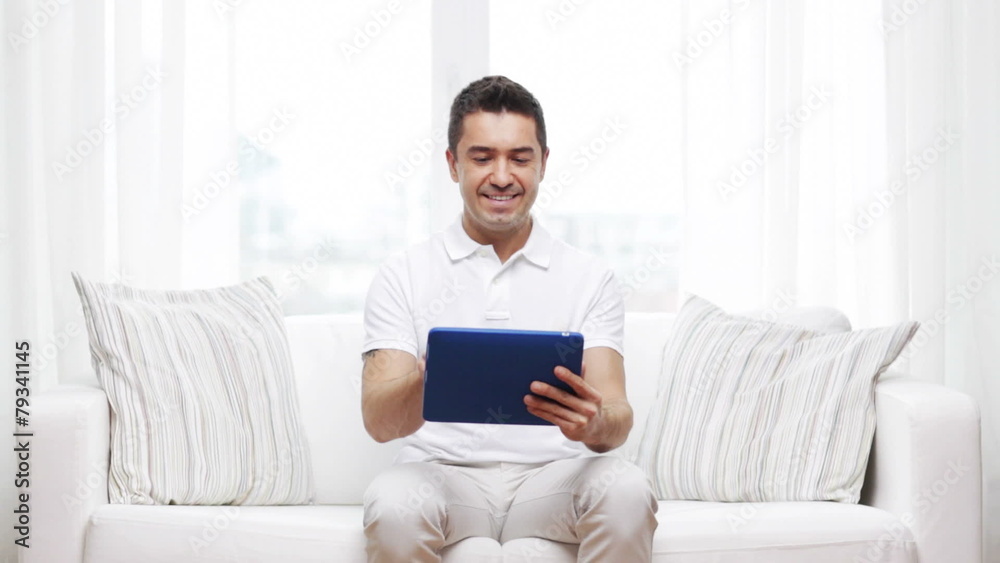 smiling man working with tablet pc at home smiling man working with tablet pc at home